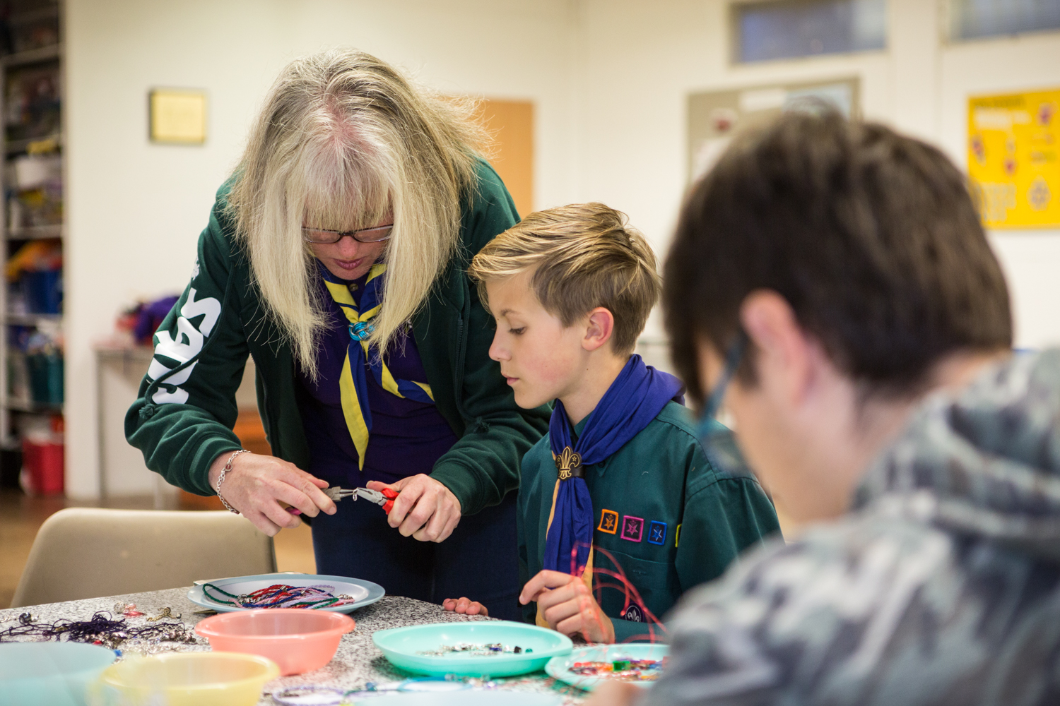 Leader doing craft with Scouts
